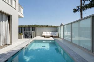 a swimming pool on the roof of a house at Villa Occasus by A&D Properties in Porto Rafti