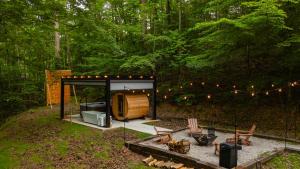 a small cabin in the middle of a forest at S'more Memories-Cold Plunge, Sauna, Hot Tub Wellness Retreat in Campton