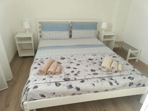 a bedroom with a bed with two slippers on it at B&B Rita in Due Maestà
