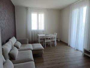 a living room with a couch and a table at B&B Rita in Due Maestà