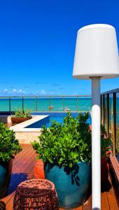 Eine Lampe auf einem Deck mit Blick auf das Meer in der Unterkunft Holanda Gold Hotel Praia de Tambaú in João Pessoa
