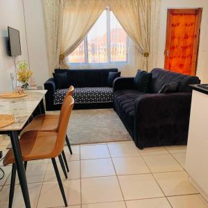 a living room with a couch and a table at Asanta Guest House in Ladysmith