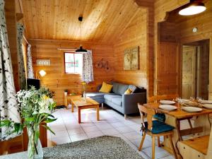 a living room with a couch and a table at Chalet Chez Jeannot, N6 in Mauroux