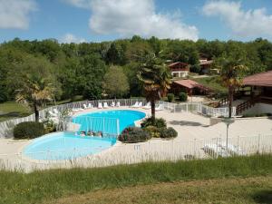 an image of a swimming pool at a resort at Chalet Chez Jeannot, N6 in Mauroux