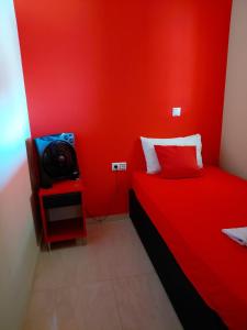 a red room with a bed and a tv at Apartments Vesna Luxury & Stefan ap 4 in Paralia Katerinis