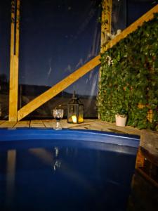 a hot tub with a candle and a lantern at Dom Vladeasa in Rogojel