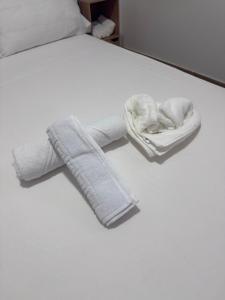 a white bed with two towels on top of it at Rooms Sincelejo in Madrid +78 photos