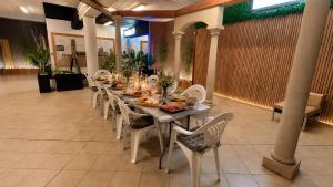 a long table with chairs and food on it at La Cantera Rural Spa in Viñaixa