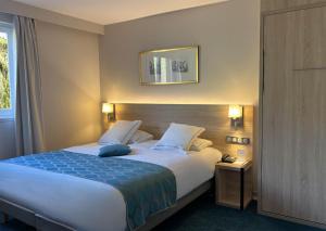 เตียงในห้องที่ Best Western Plus Hotel & SPA Le Schoenenbourg