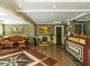 a living room with a couch and a fireplace at Club Bali Suite Legian in Legian +22 photos