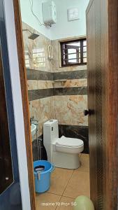 a bathroom with a toilet in a room at Riverside Bliss Villa in Kallar-Bridge +19 photos