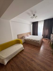 a bedroom with two beds and a ceiling fan at Brown Aparts in Chişinău