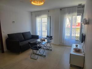 a living room with a couch and a table at Casa Andrea in Puerto Real