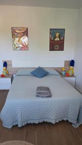 a bedroom with a large bed with two stuffed animals on it at The Simpsons in Seville in Mairena del Aljarafe