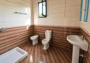 a bathroom with a toilet and a sink at Casa in Durrës +46 photos