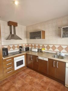 a kitchen with a sink and a stove top oven at Casa Ariño Ruidera in Ruidera