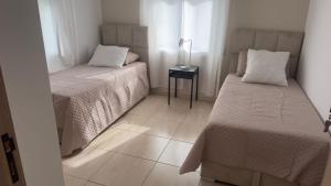 a small room with two beds and a table at Spacious villa, sea view in Cabo Negro +29 photos