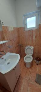 a bathroom with a white sink and a toilet at Boračko Lake View Apartment "doelend" in Konjic +16 photos
