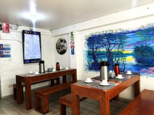 a room with two tables and a painting on the wall at Magdalen House in Lima +25 photos