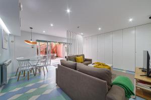a living room with a couch and a table at BeSmart Suites with Private WC by Home Sweet Home Aveiro in Aveiro