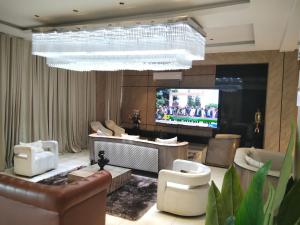 a living room with a couch and a television at DE-WILLIAMS PLACE hotel in Ibadan