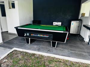 a pool table is sitting on a patio at Sombra de Macaneta in Marracuene