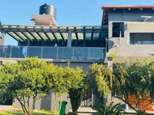 a building with trees in front of it at Sombra de Macaneta in Marracuene