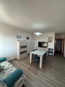 a living room with a table and chairs in it at Dimora Vicky - La Ciaccia in Valledoria +21 photos