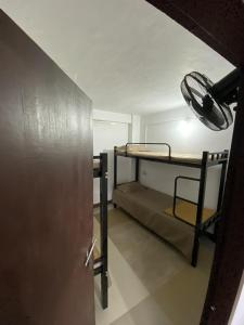 a room with two bunk beds and a door at Sleek Haven Dormitory in Meppādi