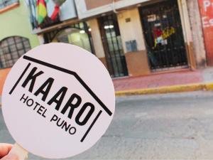 a hand holding a sign that reads harro hotel run at Kaaro Hotel Puno in Puno