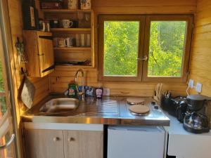 a small kitchen with a sink and a window at Roulotte à figeac in Figeac