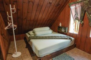 a bedroom with a bed in a wooden room at Balian Jus in Tuktuk Siadong