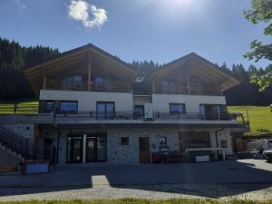 a large house with a porch and a balcony at Affittacamere Sbulìa in Santo Stefano di Cadore