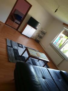 a living room with a couch and a table at Apartman Bistrivoda 2 in Vogošća