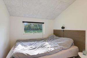 a bedroom with a bed and a window at JB415-Fjerritslev-Ahornvej-18 in Fjerritslev