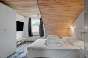 a bedroom with a large bed with a wooden ceiling at 4025-Borre-Liselundvej-20 in Borre