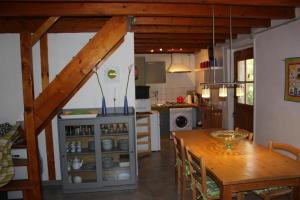 a kitchen and dining room with a table and a dining room at Bergerie - piscine privée in Cadrieu