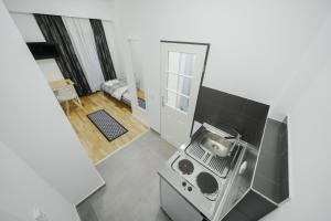 a kitchen with a stove top oven in a room at Boardinghaus Perani in Augsburg