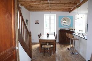 a kitchen with a table with a cat sitting on it at Le Jardin Aux Lilas in Cadrieu