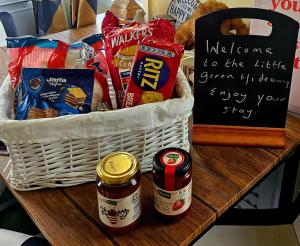 a basket of food and snacks on a table at The Little Green Hideaway in Fivemiletown +20 photos