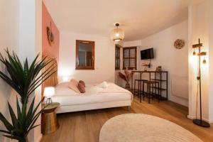 a living room with a white couch and a table at Nouveau - Le CityScape - Petite Venise in Colmar +6 photos