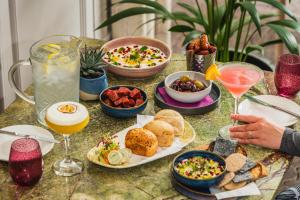 a table topped with plates of food and drinks at Lodore Falls Hotel & Spa in Keswick