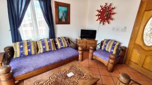 a living room with a couch and two chairs at Beach Condo 7- Upper Floor near Balandra fast WiFi in La Paz