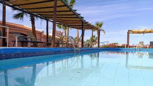 a large swimming pool with a playground in a resort at Beach Condo 7- Upper Floor near Balandra fast WiFi in La Paz