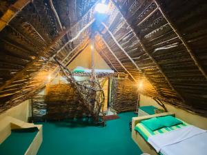 a room with two beds and a ceiling with lights at The Forest Edge Resort in Dambulla
