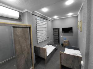 a room with two beds and a television at The Art Hotel by Art Hostel in Yakkasaray +88 photos