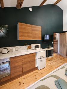 a kitchen with wooden cabinets and a white appliance at Suite Sunan in Toulon