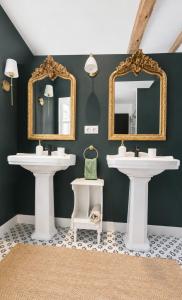a bathroom with two sinks and two mirrors at Suite Sunan in Toulon