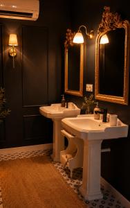 a bathroom with two sinks and two mirrors at Suite Sunan in Toulon +2 photos