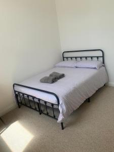 a bed in a bedroom with a blanket on it at Sunny Cottage in Camborne